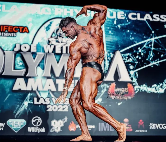 Dan Calicchia posing on stage at the Joe Weider Olympia Amateur, Classic Physique